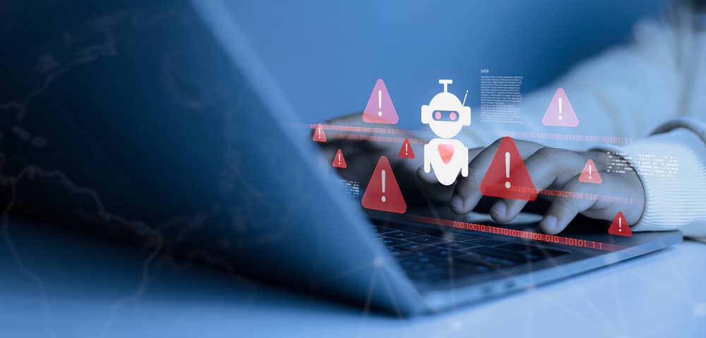 Phishing con Inteligencia Artificial: Cómo están cambiando las Ciberamenazas 24 Manos tecleando en un portátil con alertas de phishing con IA. Aprende a defenderte de los ataques de ingeniería social.